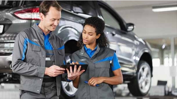 Ford Certified Service Technicians diagnosing vehicle battery